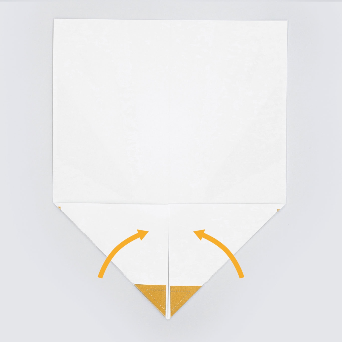 Next fold the top two corners inward until they meet in the middle creating a point.