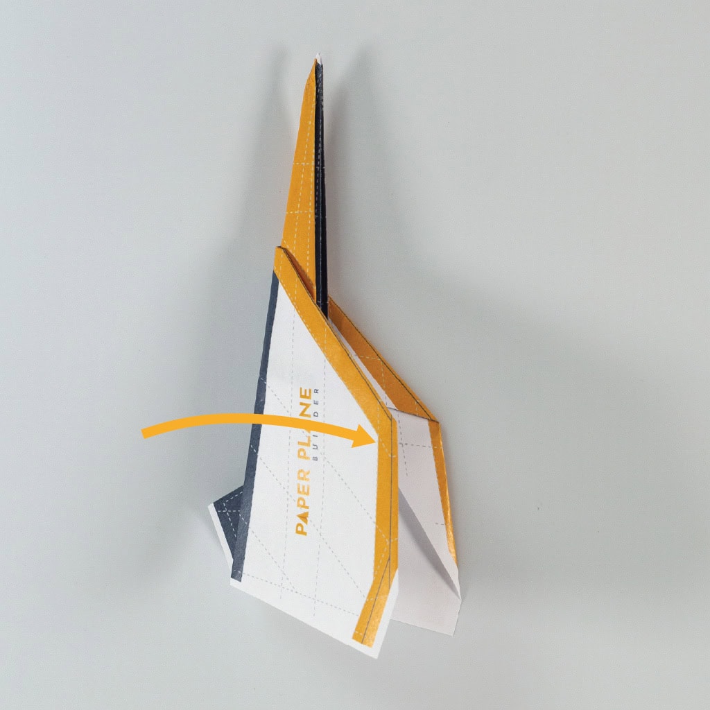 Fold the wings along the top of the fuselage so that they meet evenly on the right.