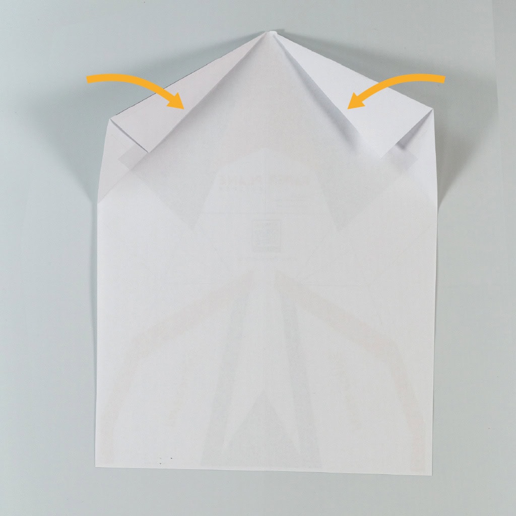 Fold the newly created flaps flat again then fold the corners inward to meet the crease from the previous fold.