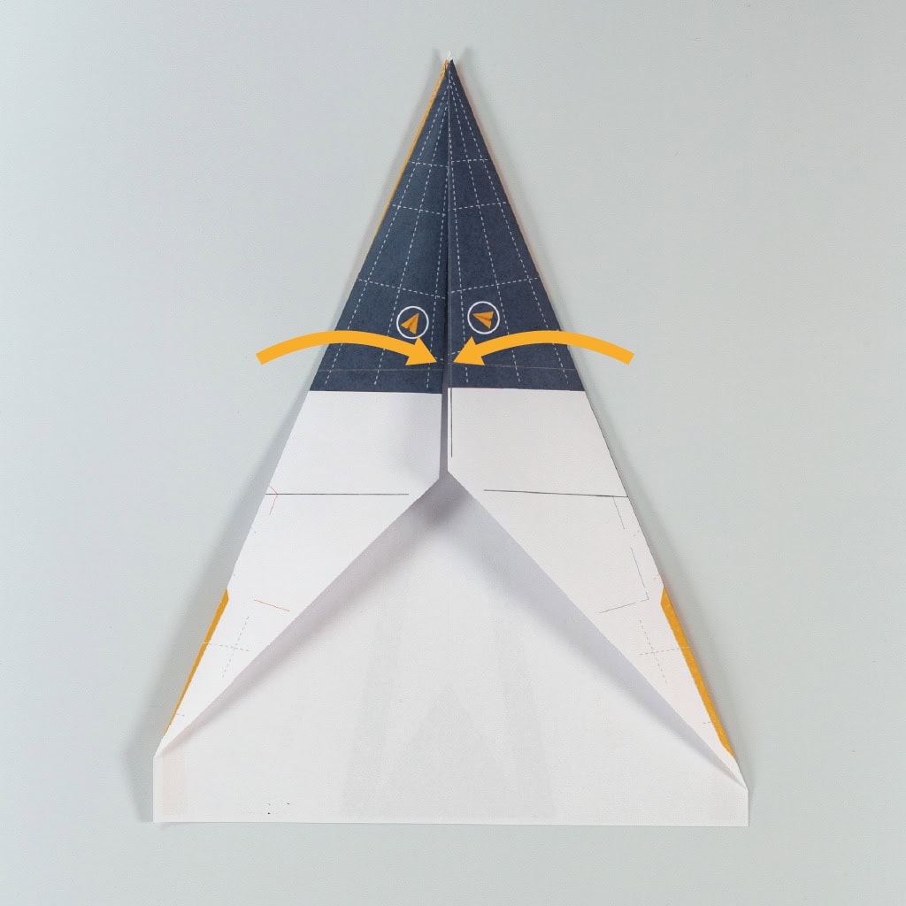 Fold the top right and left edges inward to meet in the middle.