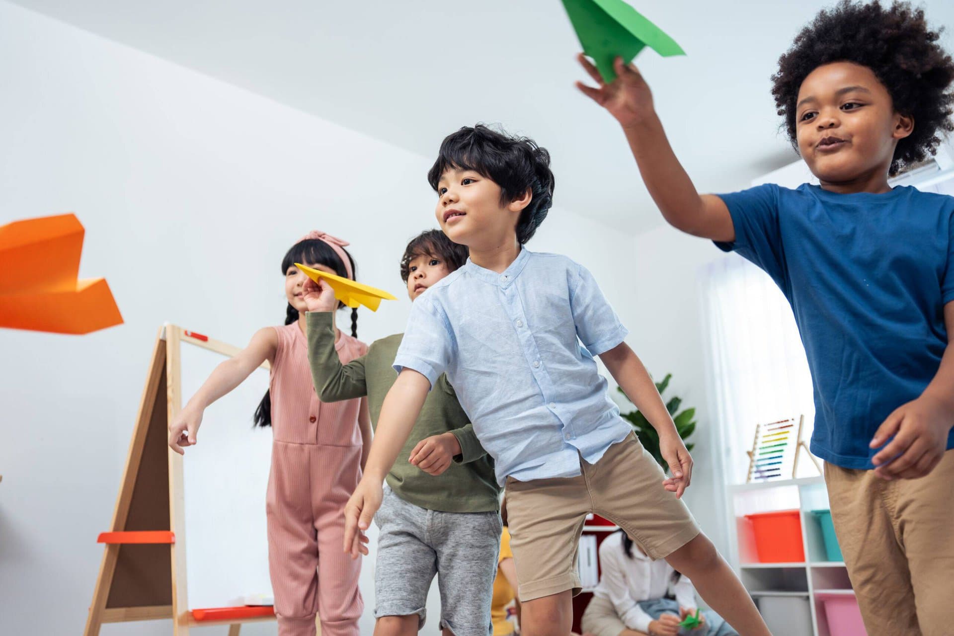 students throwing paper airplanes in a race to the finish line