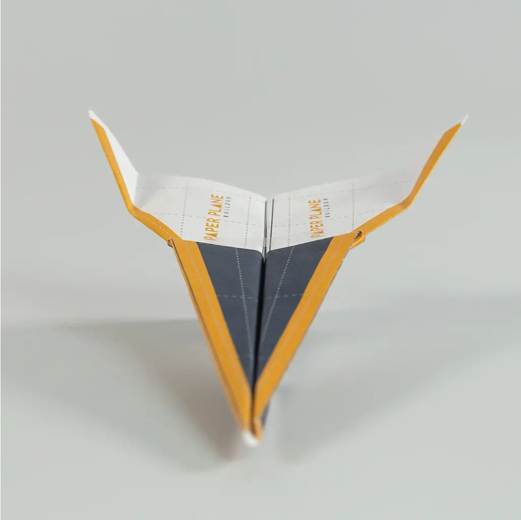Reshape the paper airplane. Try folding the wing tips up to help with accuracy.