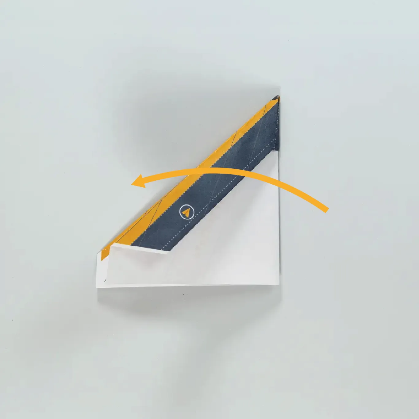 Fold the plane along the center to create the fuselage and wings.