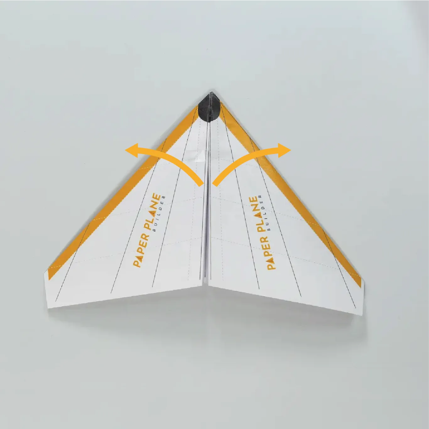 Flatten the wings to complete the glider’s shape and add a small piece of tape just behind the nose to help the plan hold it’s shape.