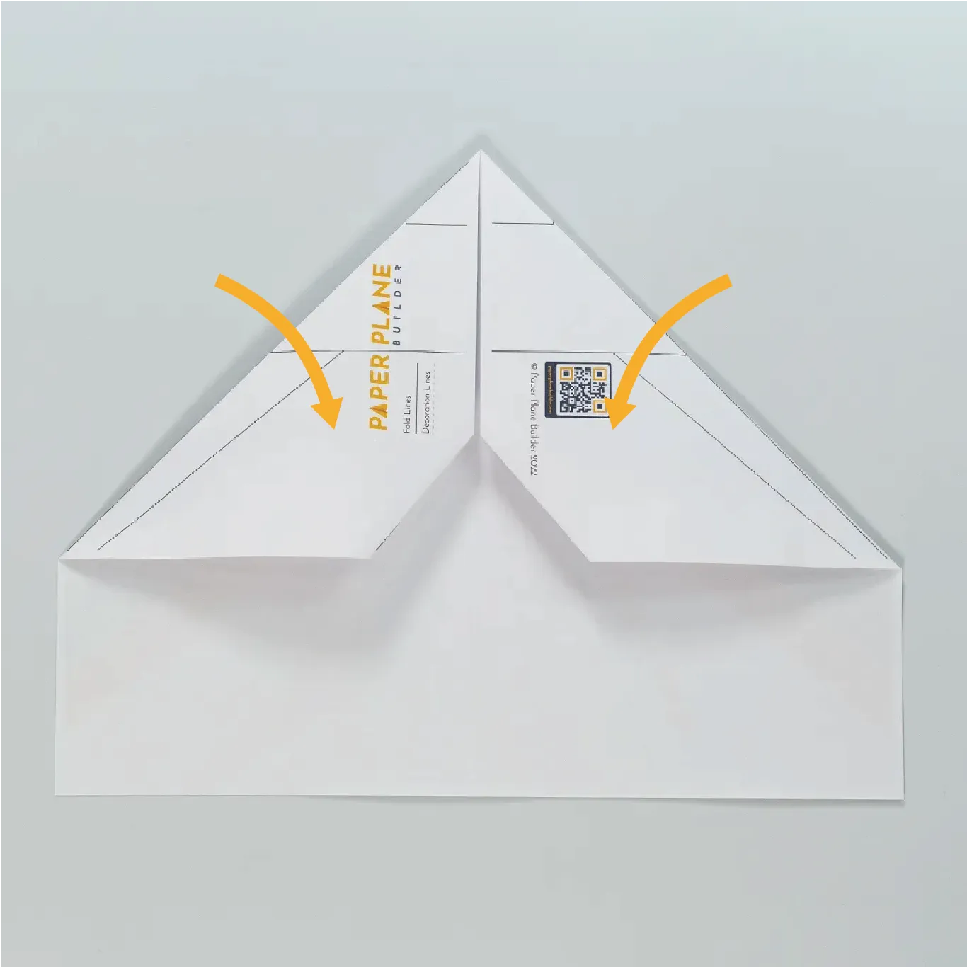 Fold the upper left and right corners inward again.
