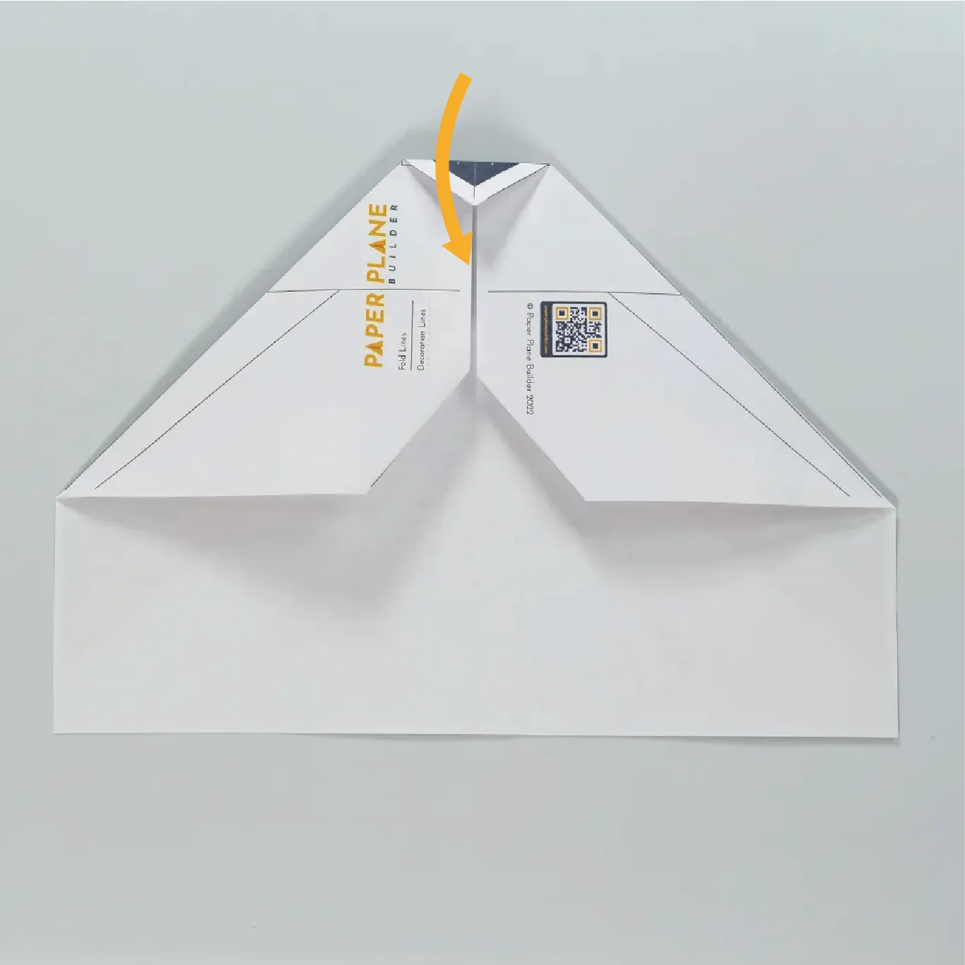 Fold the newly created nose of the plane toward you.