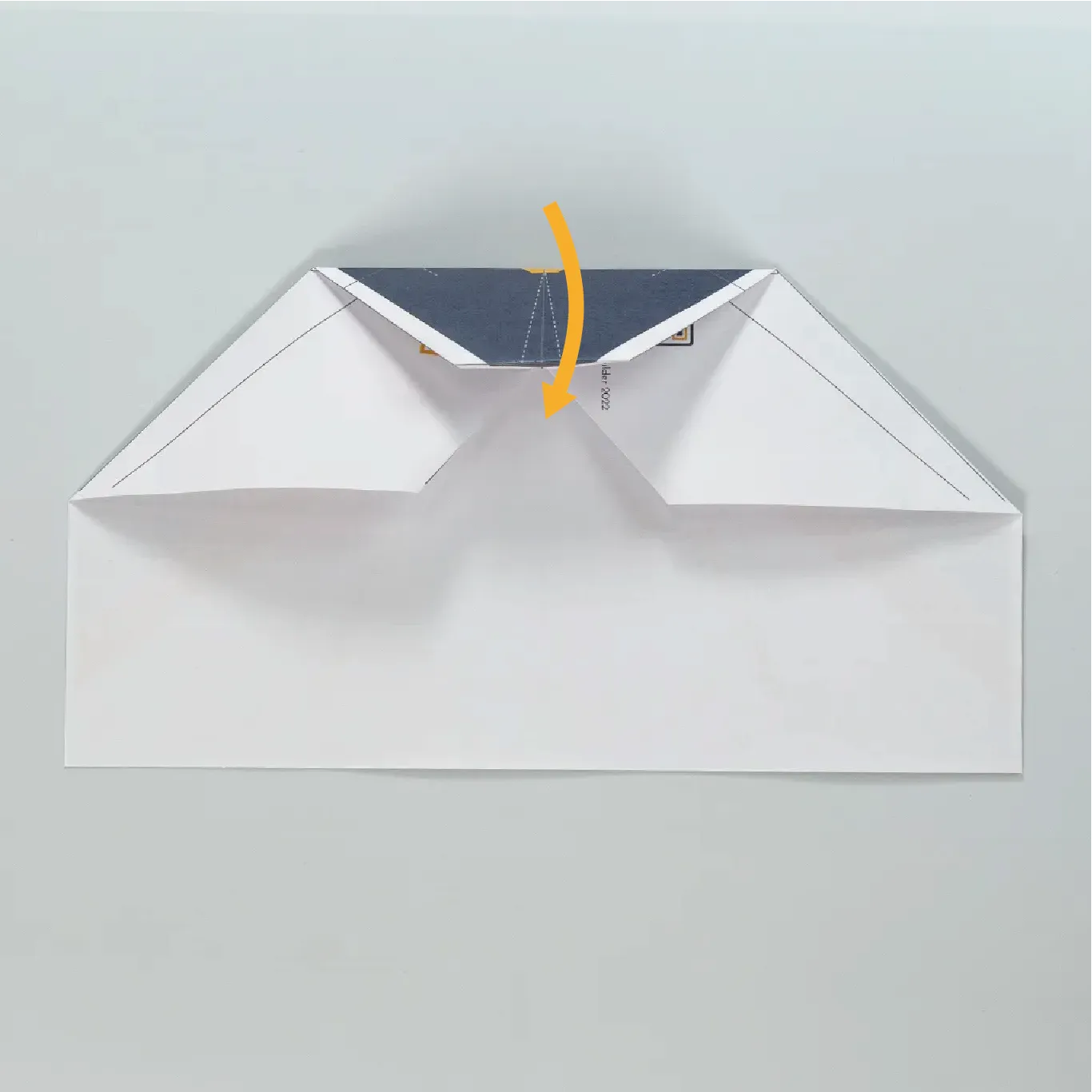 Fold the nose of the plane toward you again.