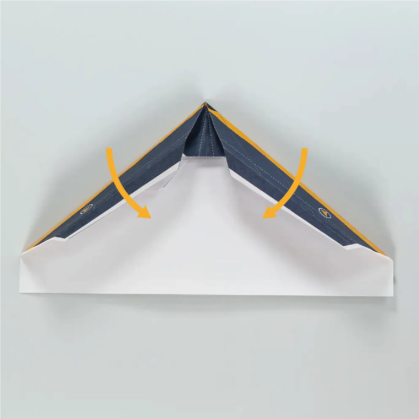 Fold the edge of the left and right wings inward again.