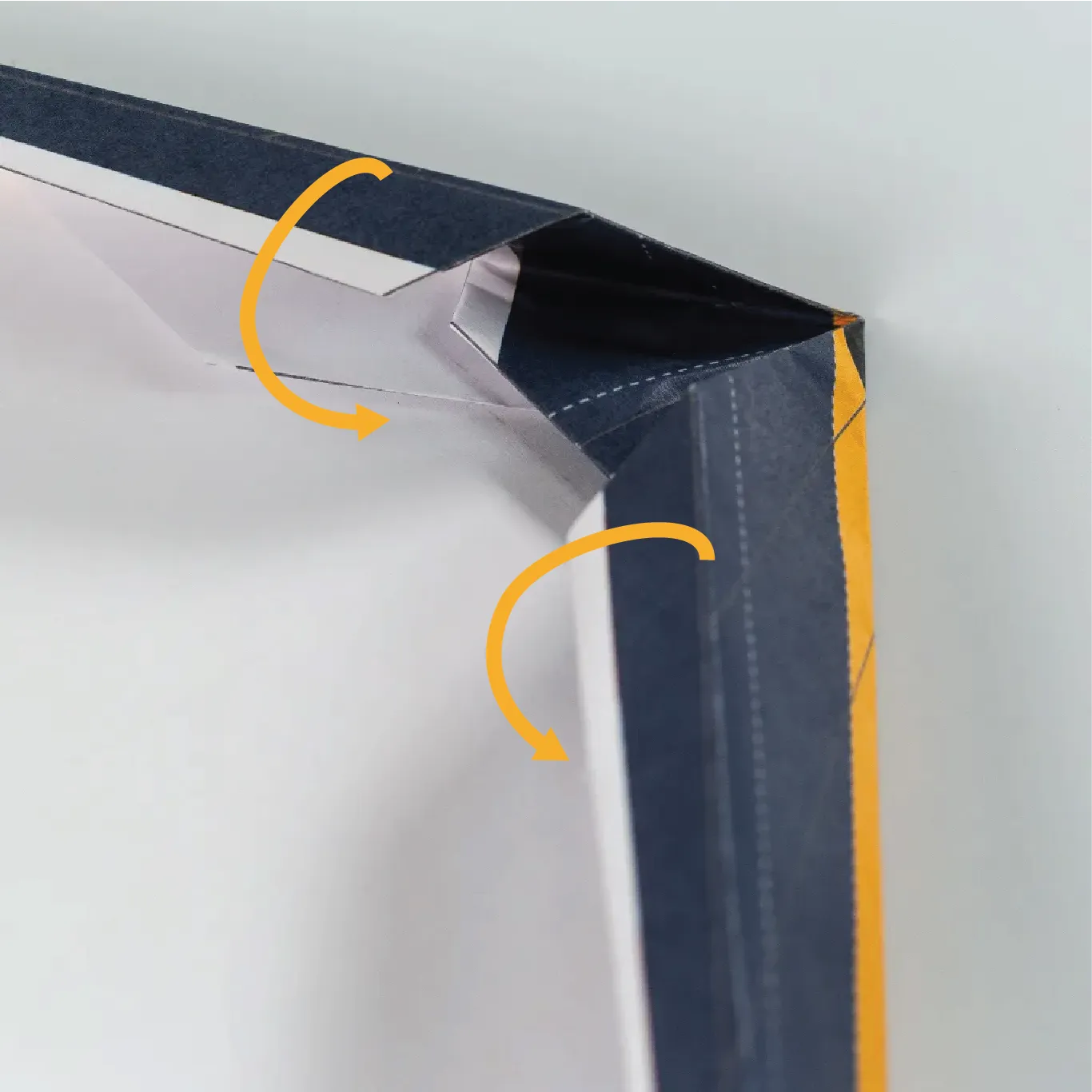 Slip the first wing fold under the nose of the plane.
