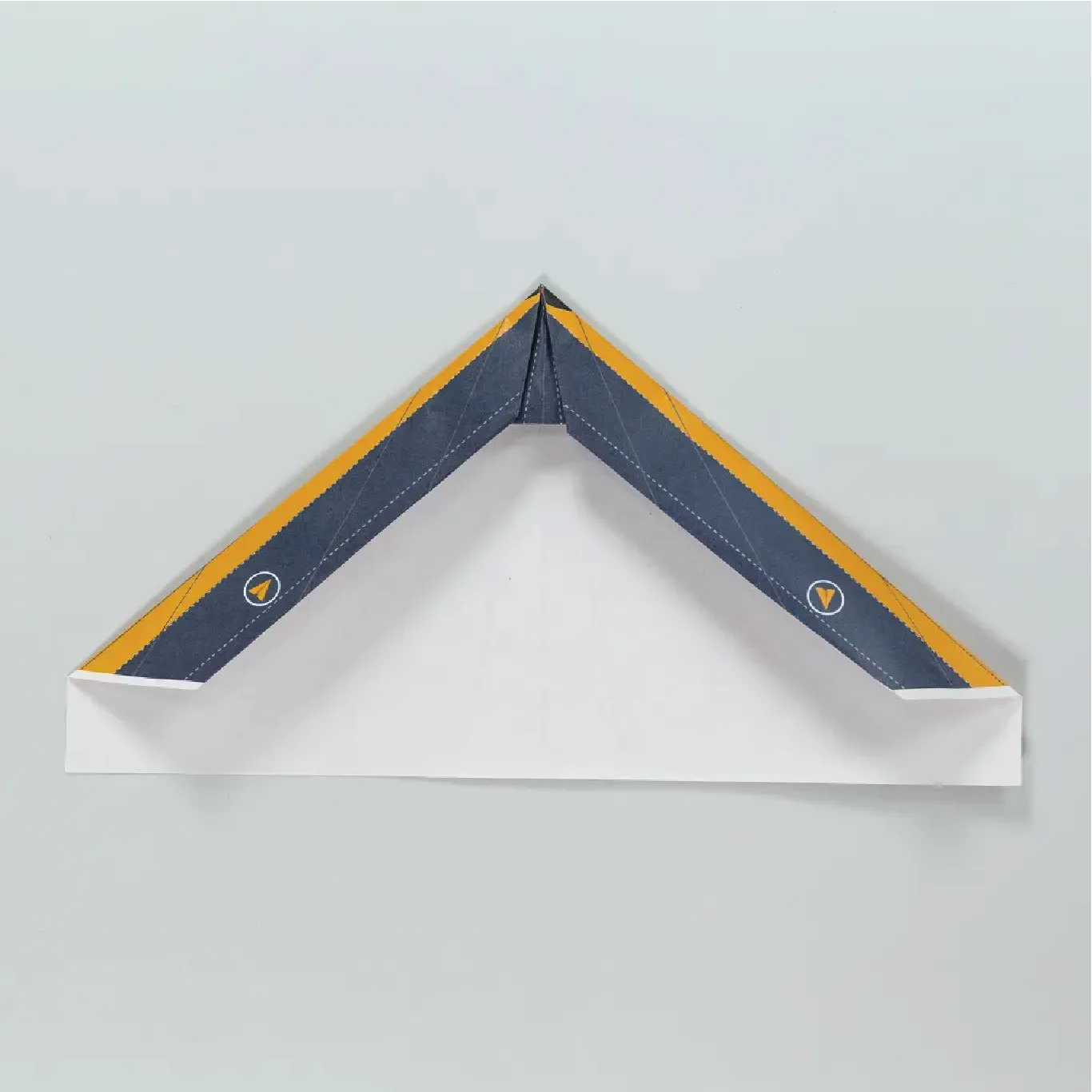 Crease the wing and nose folds to tie the paper plane together.