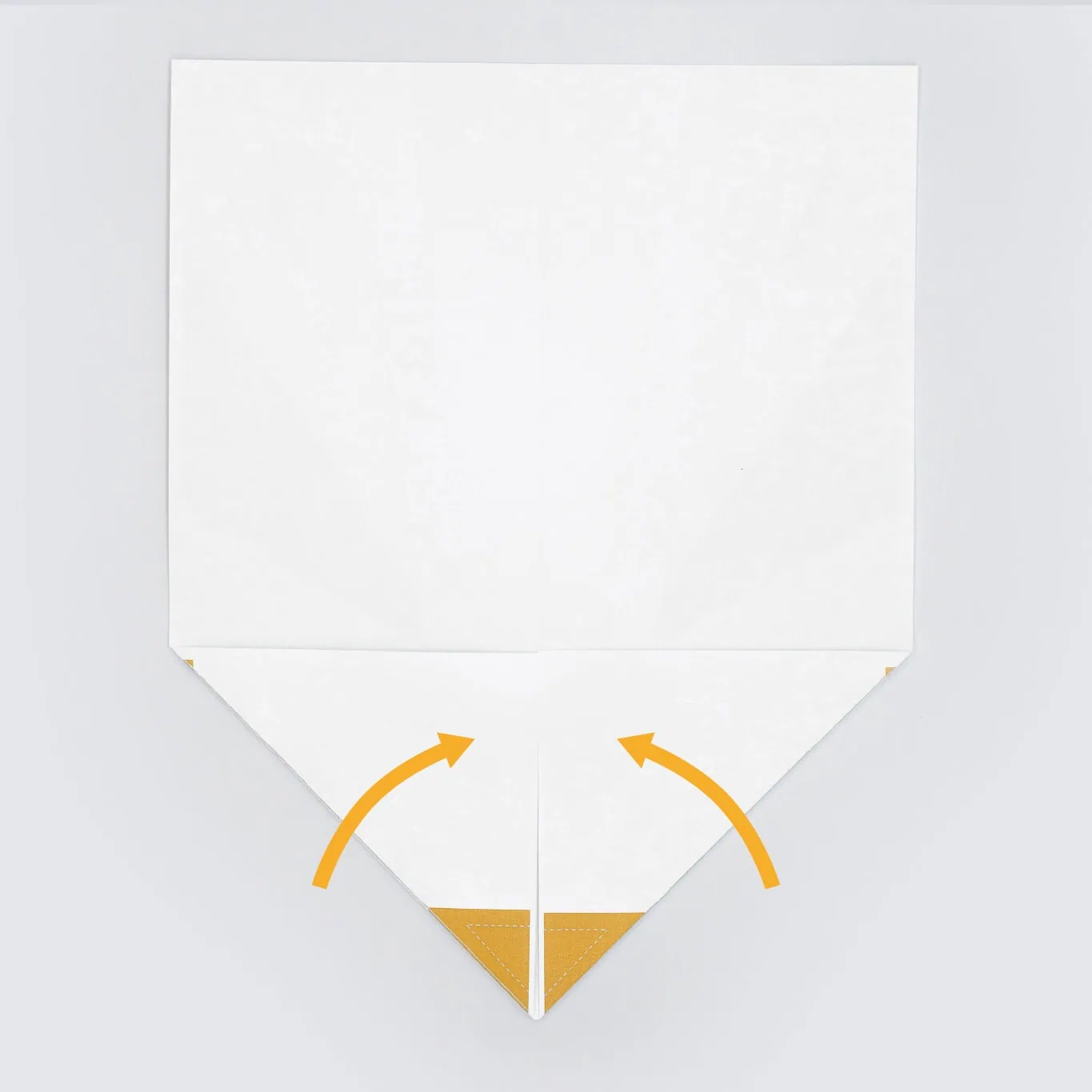 Next fold the top two corners inward until they meet in the middle creating a point.