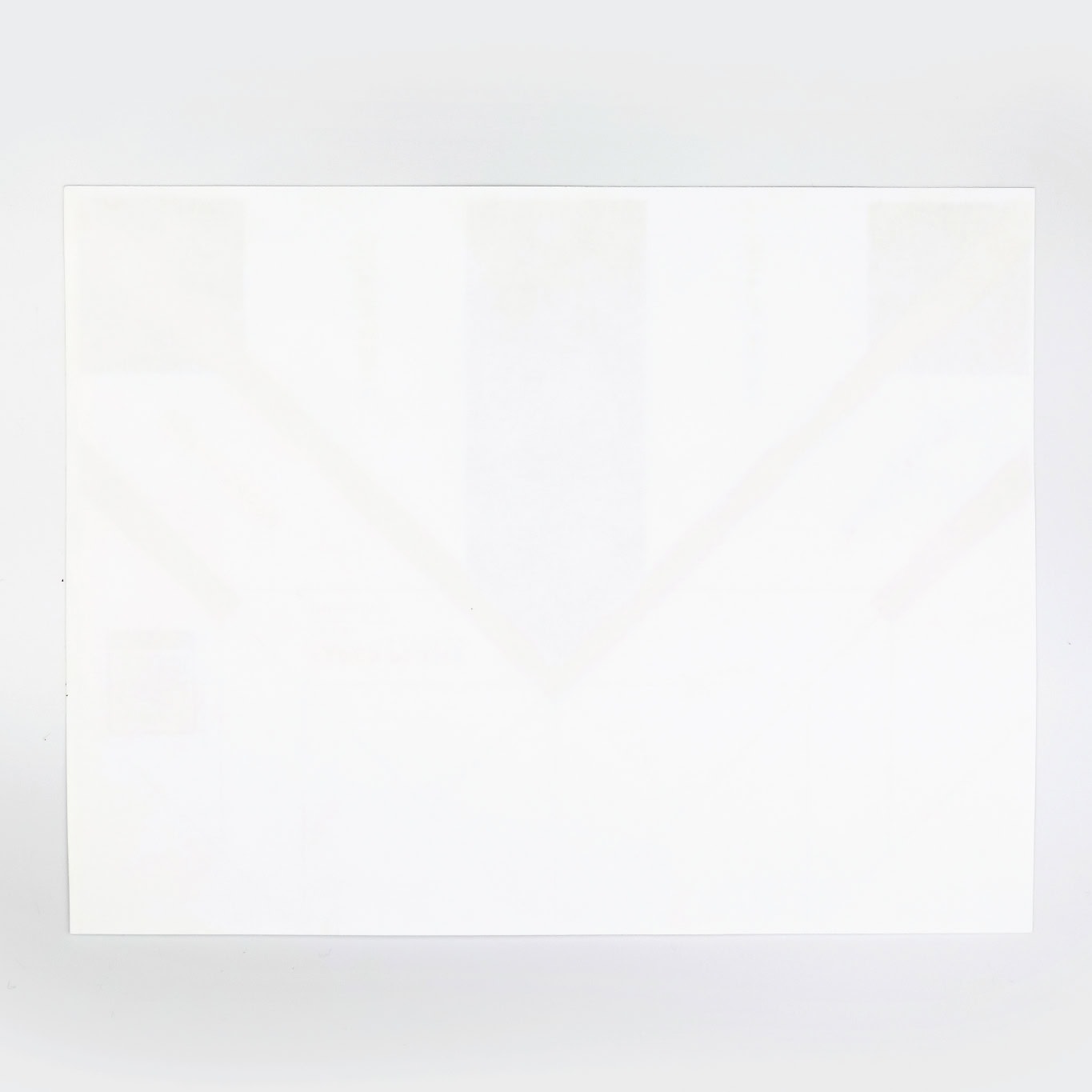 Lay the paper custom airplane template on the flat surface with it's graphics pointing down and the nose pointing toward you.