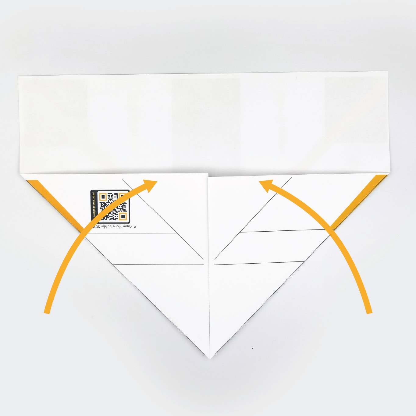 Fold the lower left and right corners up until they meet in the middle of the page.
