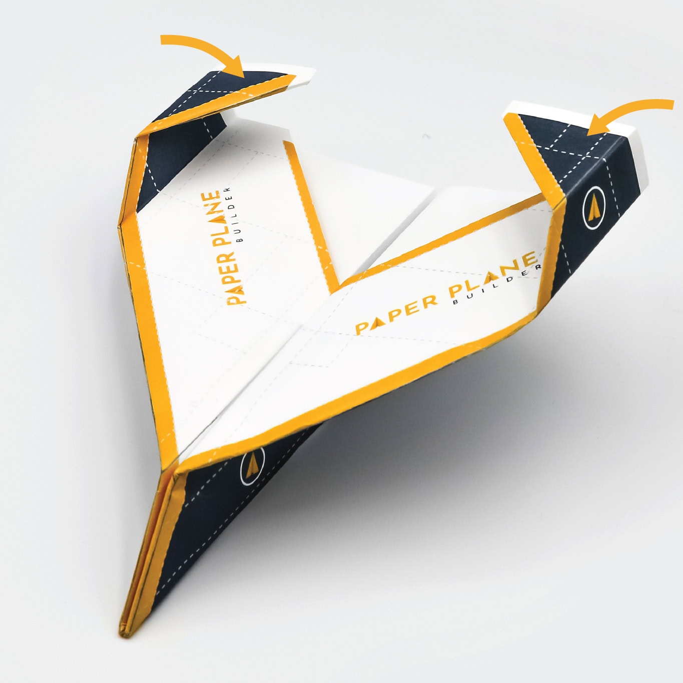Finish the winglets by folding the small wing tips inward and add a small piece of tape to the top of the plane to maintain it’s shape.